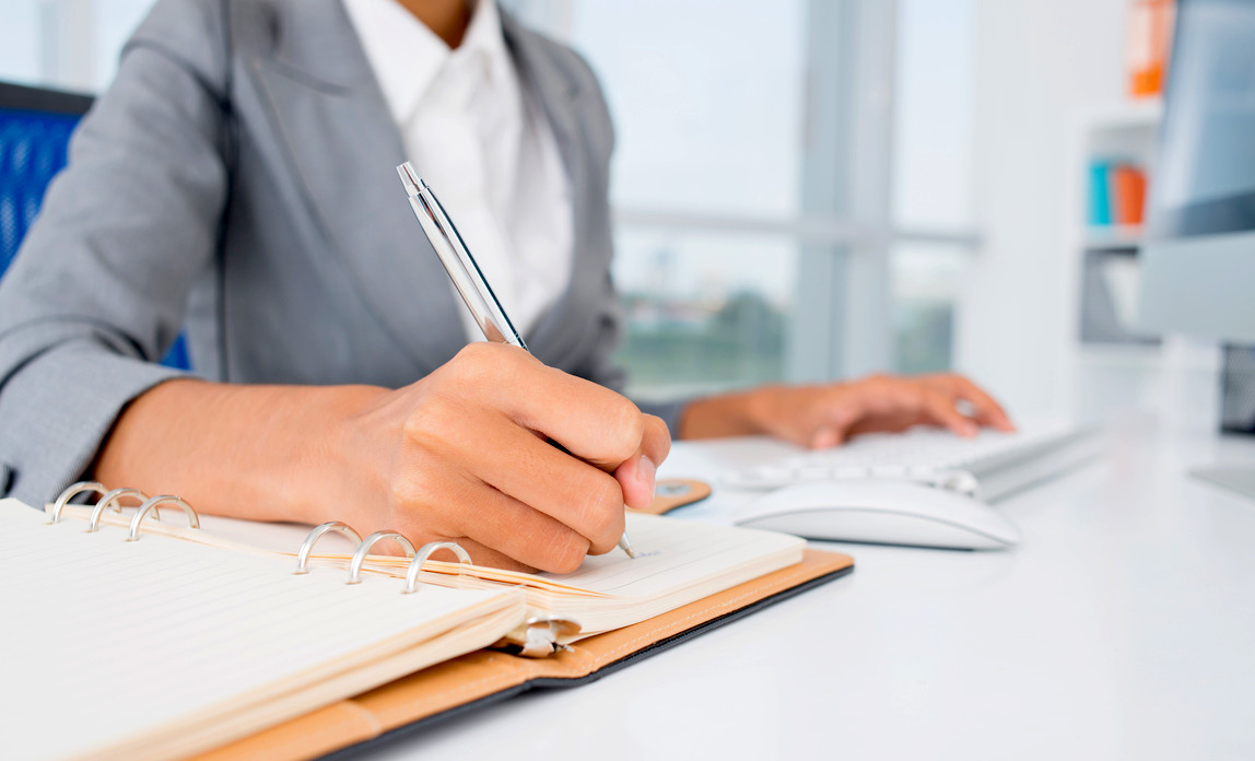 Woman at desk writing